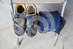 Dirty shoes and T-shirt with dust footprint of worker on the stair of ladder