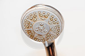 Dirty shower head with limescale and rust on it photo