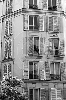 Dirty shutters on random urban windows. Run-down urban multi dwelling unit apartment block in a state of disrepair