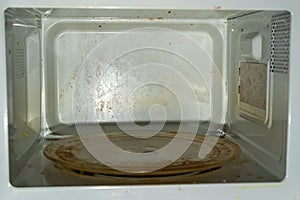The dirty, soiled inside of the microwave oven