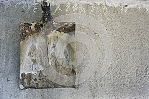 Dirty spade on the concrete surface