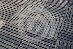 Dirty square wood decks arranged on the floor