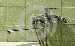 Dirty tap, in an old bathroom, limescale on the faucet. Concepts of dirty drinking water and water consumption.