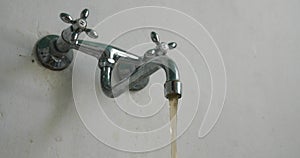 Dirty tap water Hand is opening faucet