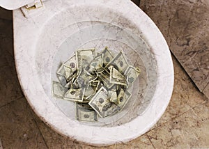 Dirty toilet with money