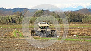 Dirty tractor working in a spanish paddy field