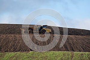 Dirty truck on a landfill recultivation area