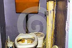 Dirty unhygienic toilet bowl with limescale stain at public restroom