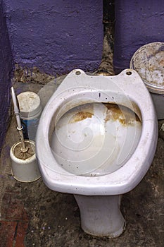 Dirty unhygienic toilet bowl with limescale stain at public restroom