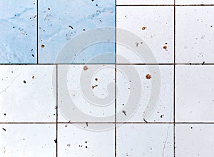 Dirty and unhygienic white and blue square bathroom and kitchen tiles