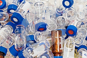 Dirty used chromatographic vials with blue caps. HPLC analysis at analytical chemistry laboratory. Development of