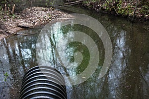 Dirty water stems from the pipe polluting the river