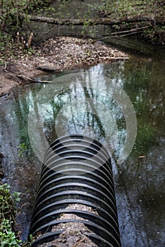 Dirty water stems from the pipe polluting the river