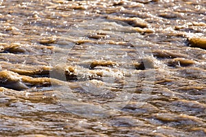 Dirty water in a stormy river as a background