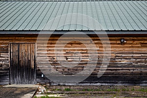 Dirty weathered wood barn building metal roof