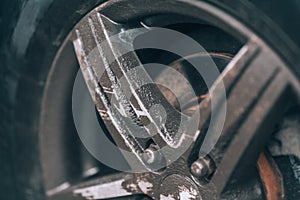 Dirty wheel. Aluminum car wheel closeup. Very dusty wheel, side view