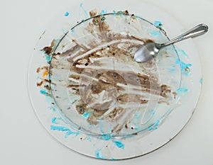Dirty white big ceramic dishes with ice cream cake stains