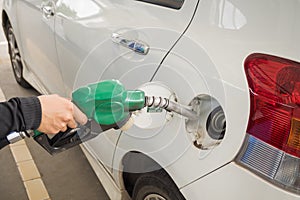 Dirty white car refueling