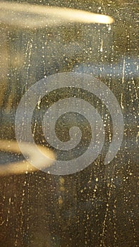 A dirty window glass with raindrops