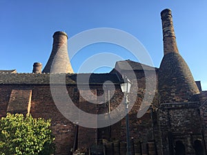 Dirty window onto bottle kilns.