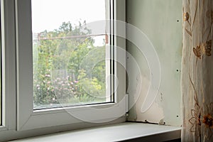 dirty window with a sill with mold from dampness, fungus on the window in the apartment