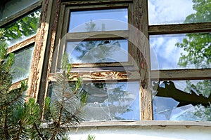 dirty wooden window frame, concept destruction of buildings from explosion, blast wave, collapse of business due to social