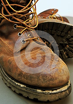 Dirty work boots with mud and scratches