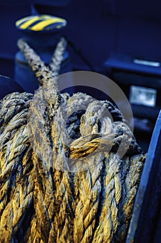 Dirtymooring line on winch. Background.  Copy space. Blur. Blue and yellow