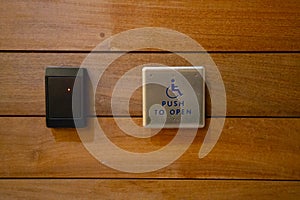 Disability access button on a wall