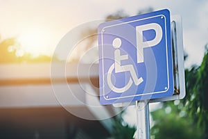 Disability car parking sign to reserved space for handicap driver photo