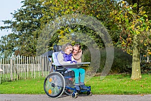 Disabled girl in a wheelchair relaxing outside