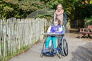 Disabled girl in a wheelchair relaxing outside