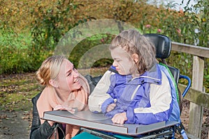 Disabled girl in a wheelchair relaxing outside