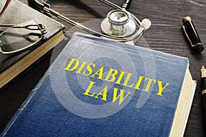 Disability Law book and stethoscope on a desk.