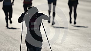 Disability sport athlete run nordic poles. Paralympic game. Man workout oudoor.