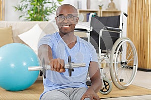 Disable man holding dumbbells in hands