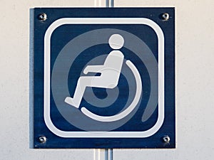 Disable toilet or WC sign on the door in blue and white