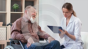 Disabled 80s grandfather consulting woman doctor having aged disease injury health problem