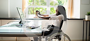 Disabled African Woman Stretching At Desk Working