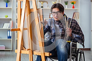 The disabled artist painting picture in studio