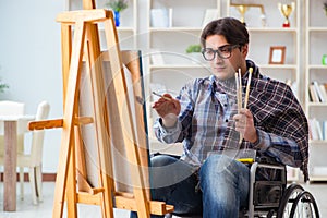 The disabled artist painting picture in studio