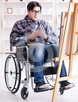 Disabled artist painting picture in studio