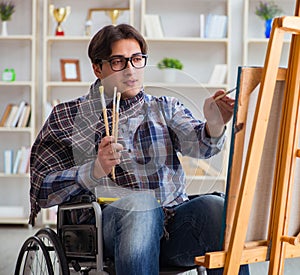 Disabled artist painting picture in studio