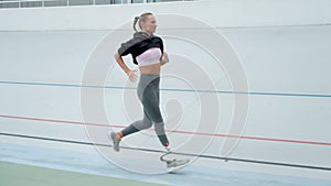 Disabled athlete woman running on sports track. Sportswoman jogging on racetrack