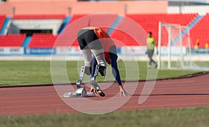 Disabled athletes prepare in starting position ready to run