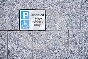 Disabled Badge Holders Only at Car Park Sign on wall