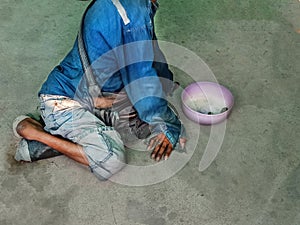 Disabled beggar sit on floor for begging