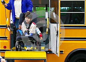 Disabled boy on bus wheelchair lift