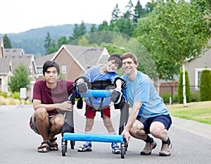 Disabled boy in walker, with father and brother