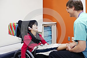 Disabled boy in wheelchair with doctor